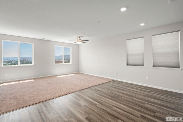empty room featuring ceiling fan, baseboards, wood finished floors, and recessed lighting