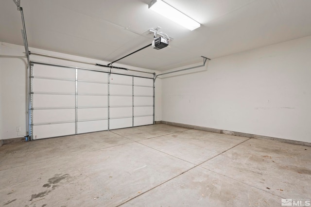 garage with a garage door opener and baseboards
