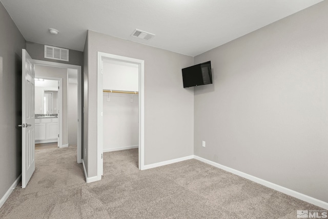 unfurnished bedroom featuring light carpet and baseboards