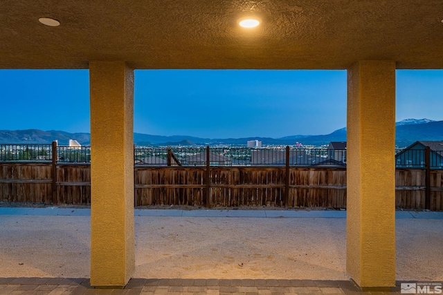 view of patio / terrace featuring a mountain view and fence