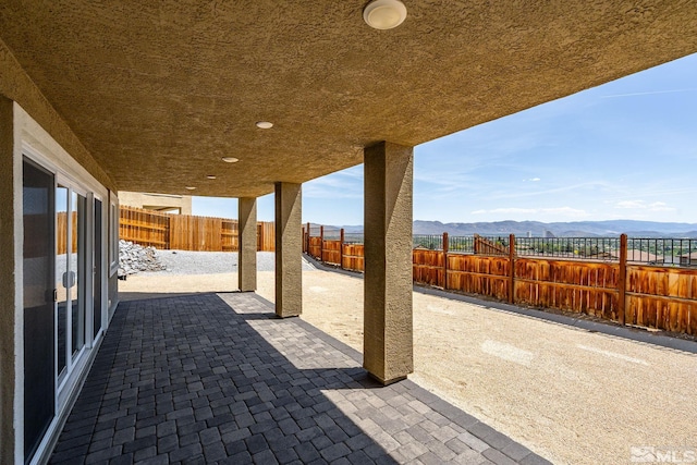 view of patio featuring a mountain view and a fenced backyard