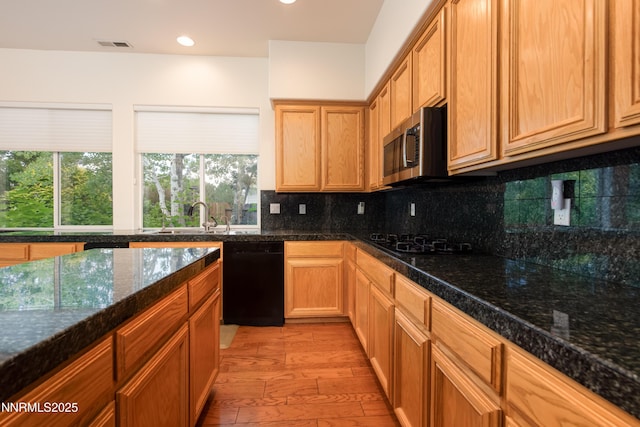 706 Norfolk Dr, Carson City, NV 89703 - kitchen featuring black appliances, light wood-type flooring, backsplash, recessed lighting, and dark stone counters