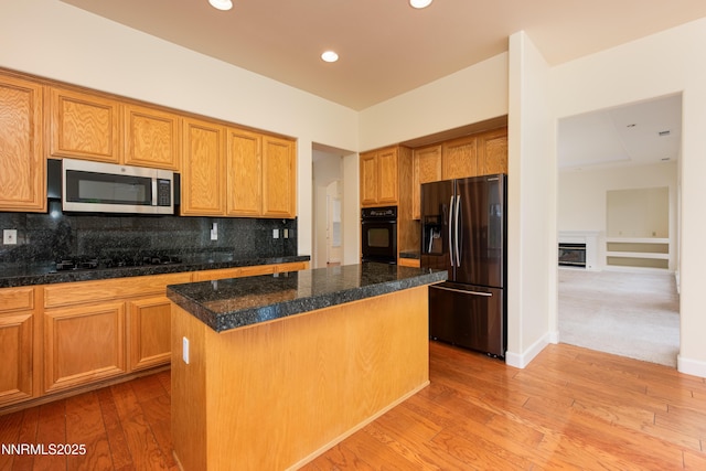 706 Norfolk Dr, Carson City, NV 89703 - kitchen featuring stainless steel appliances, a kitchen island, backsplash, a fireplace, and recessed lighting