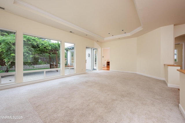 706 Norfolk Dr, Carson City, NV 89703 - carpeted empty room featuring a raised ceiling, crown molding, plenty of natural light, and arched walkways