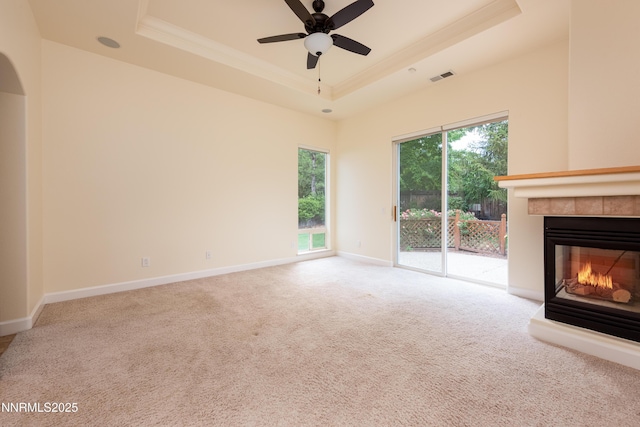 706 Norfolk Dr, Carson City, NV 89703 - unfurnished living room featuring a tray ceiling, crown molding, a fireplace, carpet flooring, and a ceiling fan