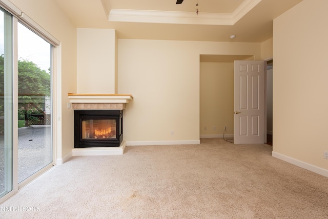 706 Norfolk Dr, Carson City, NV 89703 - unfurnished living room with a tray ceiling, a tile fireplace, crown molding, carpet floors, and a ceiling fan