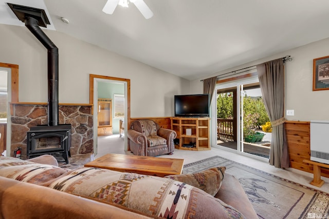 14865 N Red Rock Rd, Reno, NV 89508 - living area with a wood stove, wainscoting, carpet flooring, lofted ceiling, and a ceiling fan