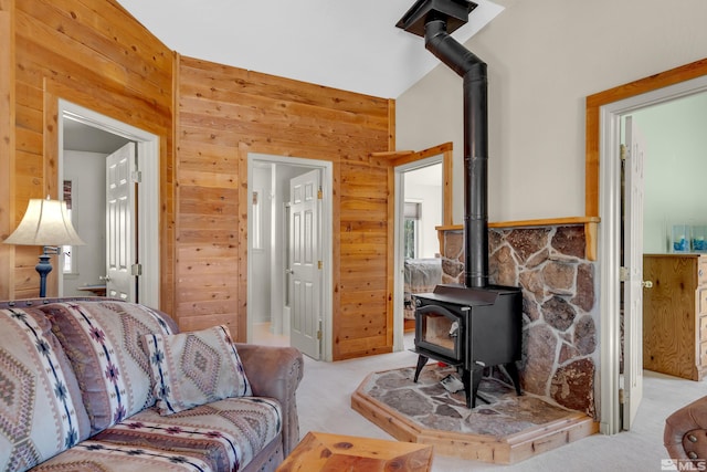 14865 N Red Rock Rd, Reno, NV 89508 - living room featuring a wood stove, light colored carpet, and wood walls