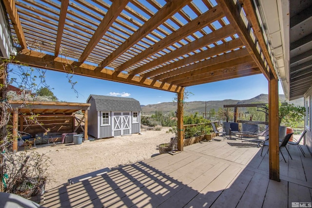 14865 N Red Rock Rd, Reno, NV 89508 - view of patio / terrace featuring a storage unit, an outbuilding, a deck with mountain view, and a pergola
