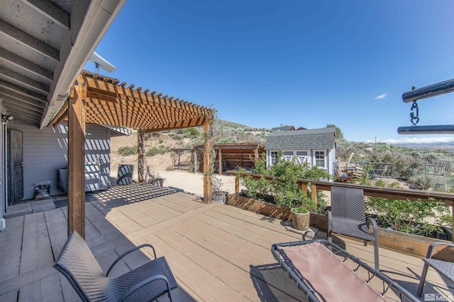 14865 N Red Rock Rd, Reno, NV 89508 - view of patio / terrace with a pergola, an outbuilding, a storage shed, a fenced backyard, and a deck