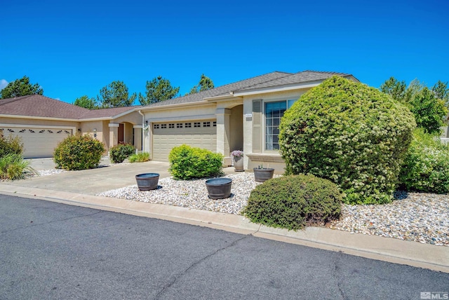1230 Quail Run Dr, Carson City, NV 89701 - single story home featuring a garage, stucco siding, and concrete driveway