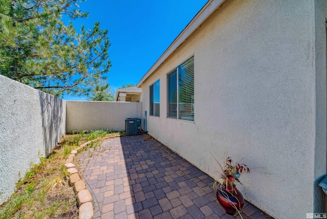 1230 Quail Run Dr, Carson City, NV 89701 - view of patio featuring central AC and a fenced backyard