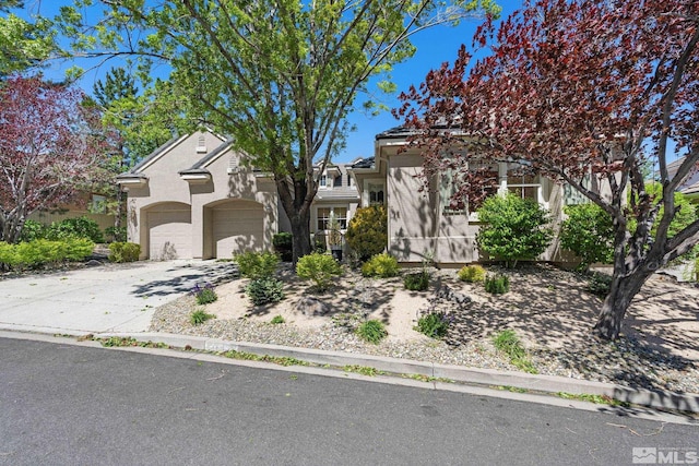 1745 Hunter Creek Rd, Reno, NV 89519 - obstructed view of property with stucco siding, an attached garage, and driveway