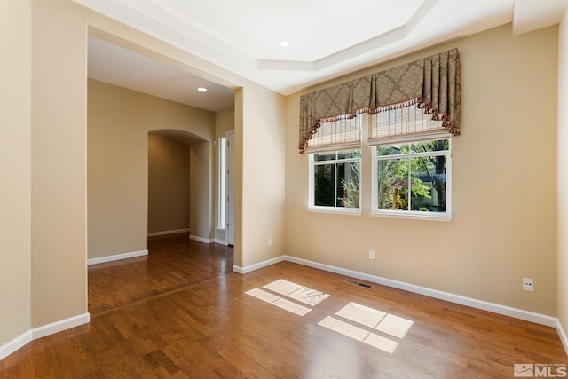 1745 Hunter Creek Rd, Reno, NV 89519 - empty room with arched walkways, wood finished floors, baseboards, recessed lighting, and a tray ceiling
