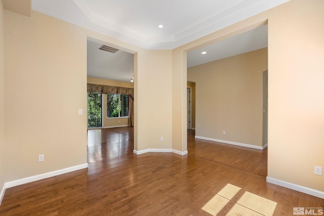 1745 Hunter Creek Rd, Reno, NV 89519 - spare room with wood finished floors, recessed lighting, baseboards, a tray ceiling, and arched walkways