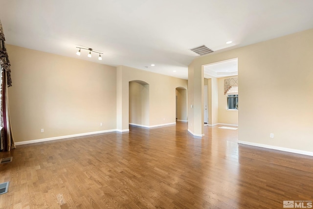 1745 Hunter Creek Rd, Reno, NV 89519 - spare room featuring arched walkways, wood finished floors, recessed lighting, and baseboards
