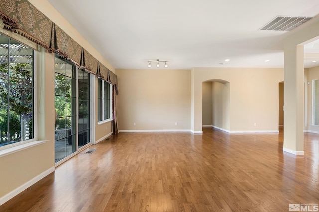 1745 Hunter Creek Rd, Reno, NV 89519 - unfurnished room with arched walkways, light wood-style floors, baseboards, and recessed lighting