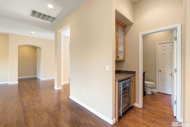1745 Hunter Creek Rd, Reno, NV 89519 - corridor featuring wine cooler, dark wood-style floors, arched walkways, recessed lighting, and baseboards