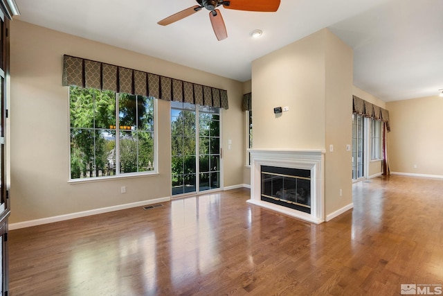 1745 Hunter Creek Rd, Reno, NV 89519 - unfurnished living room with ceiling fan, a glass covered fireplace, baseboards, and wood finished floors