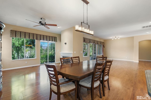 1745 Hunter Creek Rd, Reno, NV 89519 - dining room with a ceiling fan, arched walkways, wood finished floors, and baseboards