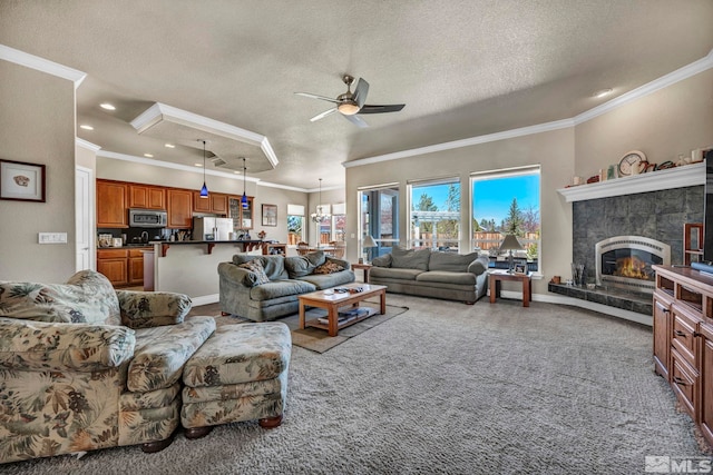 2825 N Fork Ln, Minden, NV 89423 - carpeted living area featuring a ceiling fan, a textured ceiling, ornamental molding, a tile fireplace, and recessed lighting