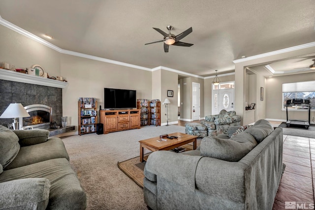 2825 N Fork Ln, Minden, NV 89423 - carpeted living room featuring a ceiling fan, crown molding, a tile fireplace, and baseboards
