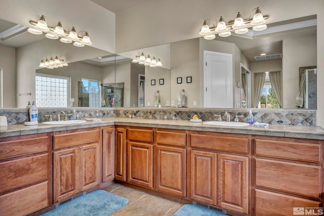 2825 N Fork Ln, Minden, NV 89423 - bathroom with tasteful backsplash, tiled shower, a chandelier, double vanity, and tile patterned flooring
