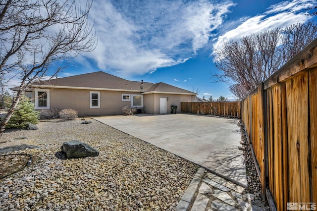 2825 N Fork Ln, Minden, NV 89423 - back of property with stucco siding, a fenced backyard, and a patio area