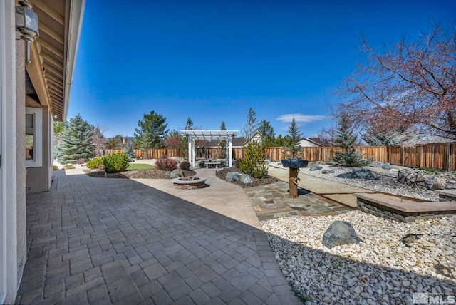 2825 N Fork Ln, Minden, NV 89423 - view of patio with a pergola, a fenced backyard, and a fire pit