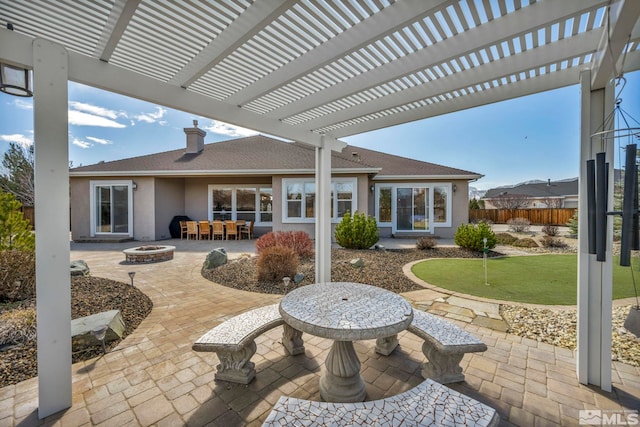 2825 N Fork Ln, Minden, NV 89423 - view of patio featuring an outdoor fire pit, an area to practice putting, fence, and a pergola