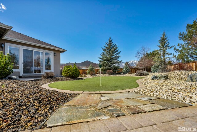 2825 N Fork Ln, Minden, NV 89423 - fenced backyard featuring a putting area and a patio
