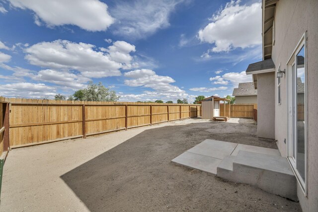 1282 Onda Verde Dr, Fallon, NV 89406 - fenced backyard featuring a shed, a patio, and an outbuilding