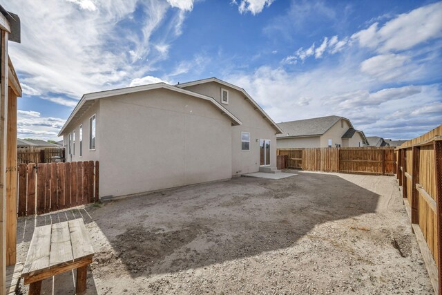 1282 Onda Verde Dr, Fallon, NV 89406 - rear view of house featuring stucco siding, a fenced backyard, and a patio
