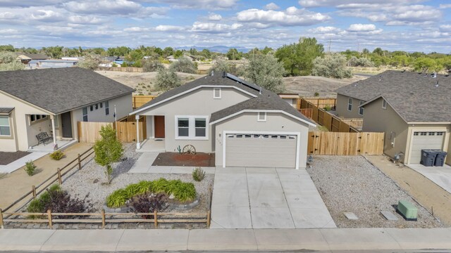 1282 Onda Verde Dr, Fallon, NV 89406 - ranch-style home with a gate, fence, roof mounted solar panels, and an attached garage