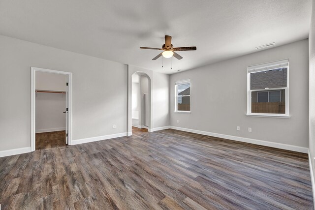 1282 Onda Verde Dr, Fallon, NV 89406 - spare room featuring arched walkways, ceiling fan, dark wood-type flooring, and baseboards