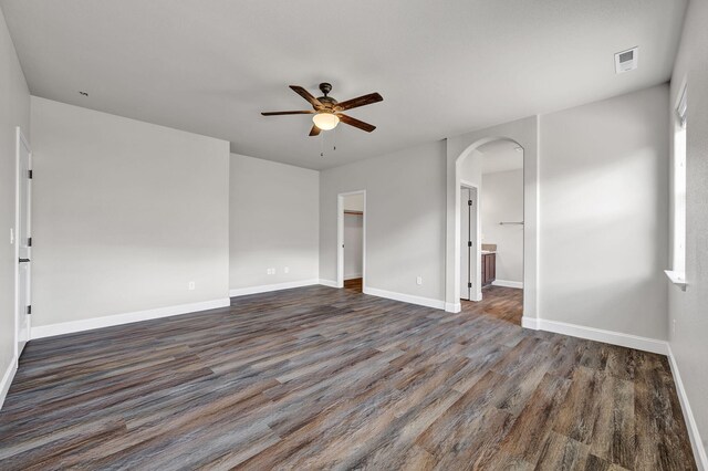 1282 Onda Verde Dr, Fallon, NV 89406 - empty room with arched walkways, a ceiling fan, dark wood-type flooring, and baseboards