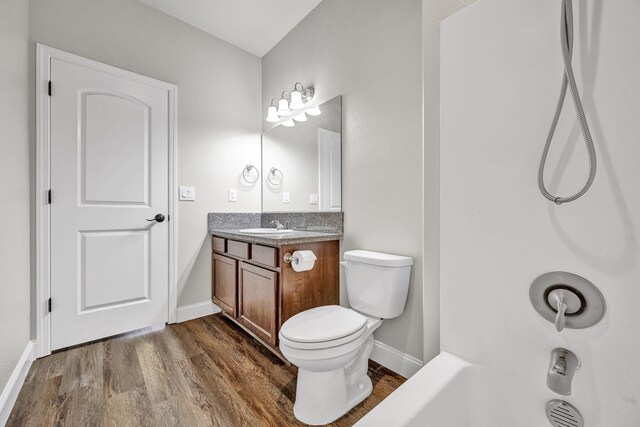 1282 Onda Verde Dr, Fallon, NV 89406 - full bathroom featuring wood finished floors, baseboards, vanity, and toilet