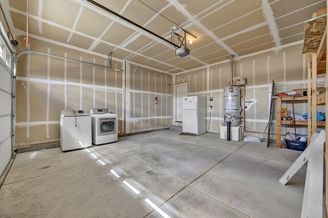 1282 Onda Verde Dr, Fallon, NV 89406 - garage with freestanding refrigerator, washing machine and clothes dryer, strapped water heater, and a garage door opener