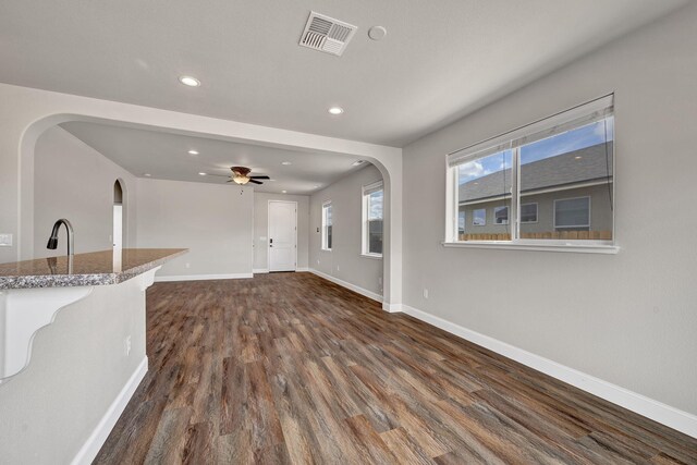 1282 Onda Verde Dr, Fallon, NV 89406 - unfurnished living room featuring recessed lighting, dark wood-style flooring, baseboards, arched walkways, and ceiling fan