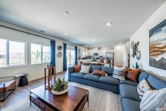 7593 Apex Pl Lot # 109, Reno, NV 89506 - living room featuring light wood-style floors, recessed lighting, and stairway