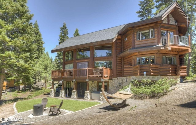 996 Tyner Way, Incline Village, NV 89451 - rear view of property with log exterior, roof with shingles, stone siding, a balcony, and a wooden deck