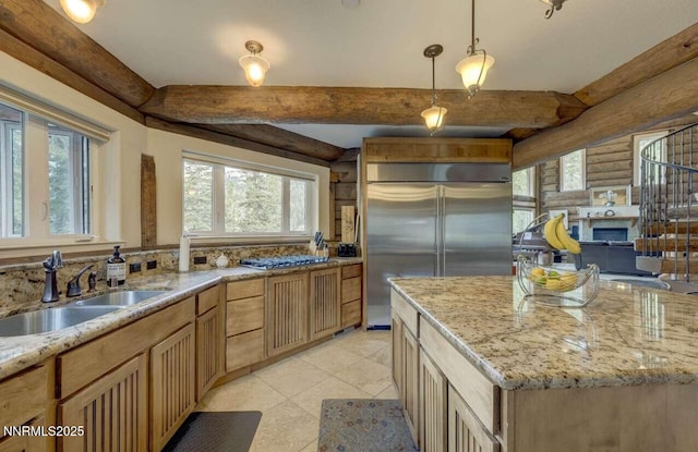 996 Tyner Way, Incline Village, NV 89451 - kitchen with stainless steel appliances, a sink, log walls, light stone countertops, and light tile patterned flooring