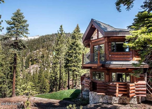 996 Tyner Way, Incline Village, NV 89451 - rear view of house with log exterior, a balcony, and a view of trees