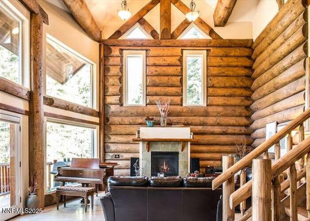 996 Tyner Way, Incline Village, NV 89451 - living room with log walls, a warm lit fireplace, and high vaulted ceiling