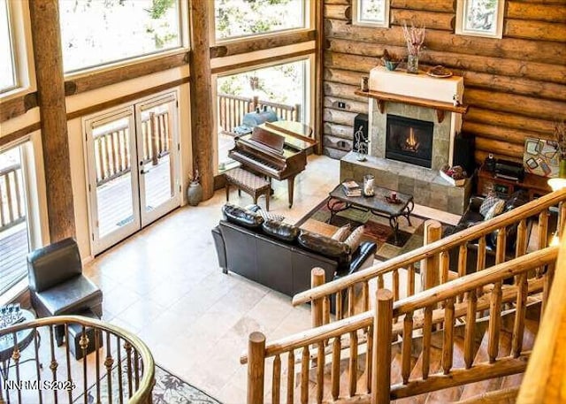 996 Tyner Way, Incline Village, NV 89451 - living room with log walls, plenty of natural light, a tiled fireplace, and a towering ceiling