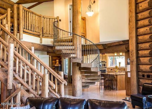 996 Tyner Way, Incline Village, NV 89451 - living room featuring stairway, a high ceiling, and log walls