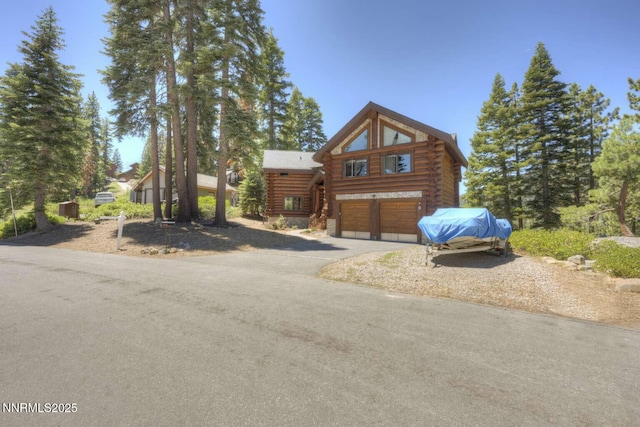 996 Tyner Way, Incline Village, NV 89451 - log-style house featuring log siding, a garage, and driveway