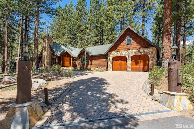 671 14th Green Dr, Incline Village, NV 89451 - view of front of property with stone siding, a garage, and driveway