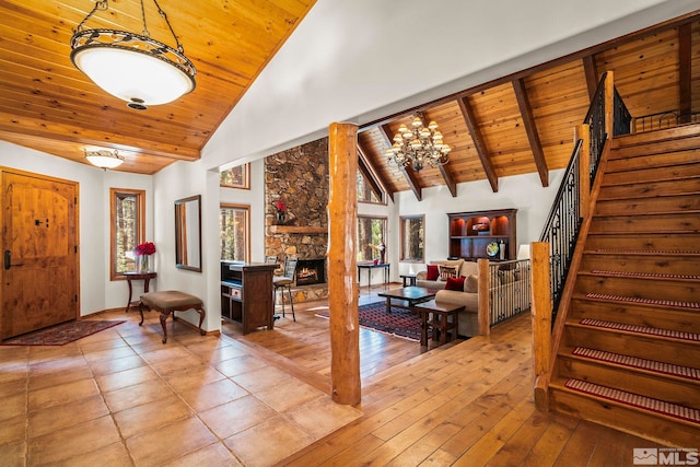 671 14th Green Dr, Incline Village, NV 89451 - foyer with wooden ceiling, high vaulted ceiling, stairs, a chandelier, and a stone fireplace