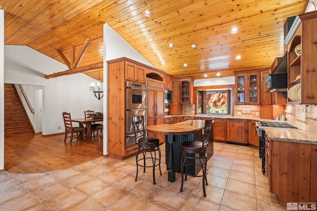 671 14th Green Dr, Incline Village, NV 89451 - kitchen with custom exhaust hood, brown cabinets, appliances with stainless steel finishes, vaulted ceiling, and glass insert cabinets